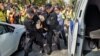 Полицейские задерживают участника акции протеста в Алматы. 21 сентября 2019 года.