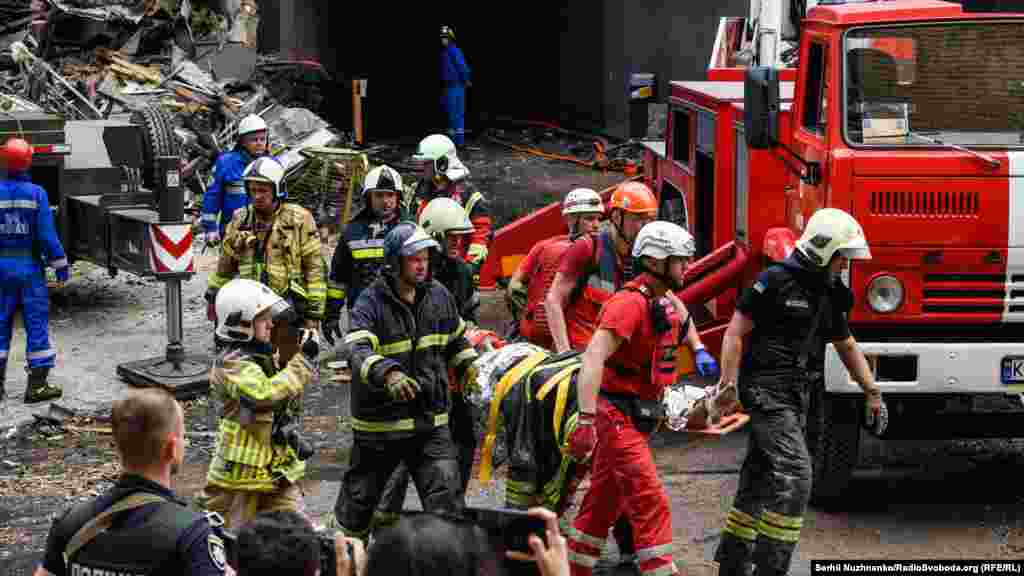 Rescuers evacuated a wounded woman from the shelled house.