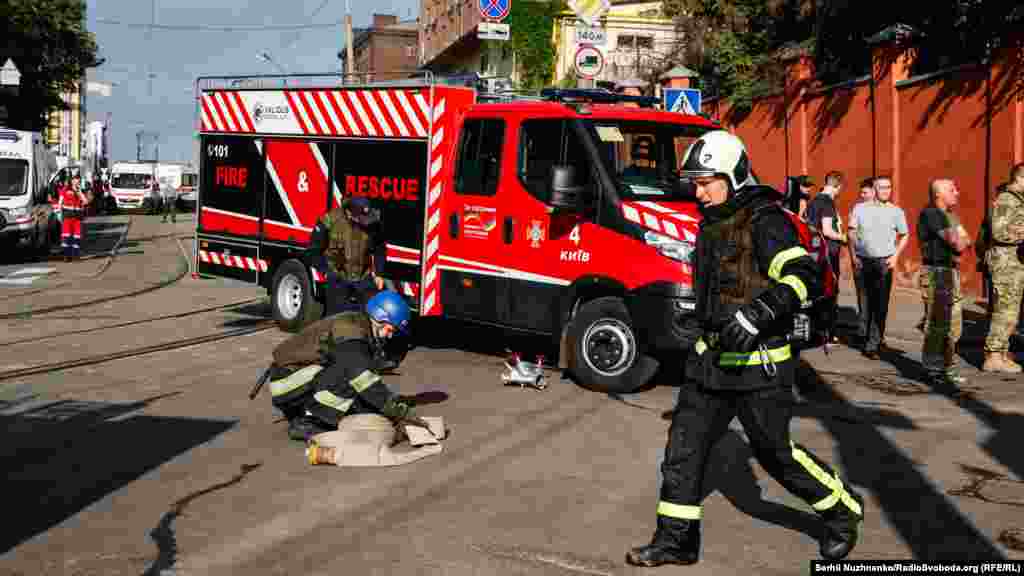 Rescuers at the site of the missile attack in Kyiv.