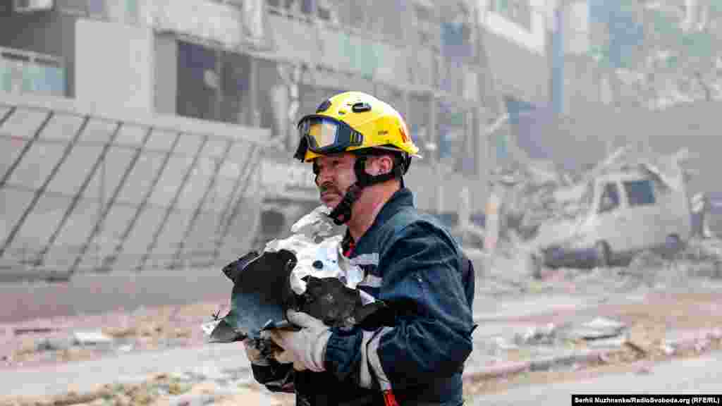 A firefighter carries the remains of the Russian rocket.