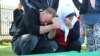 Скорбящие на памятных мероприятиях в честь 24-й годовщины резни в Сребренице. 