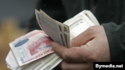 Belarus -- Belarusian money in hands, 28Feb2008