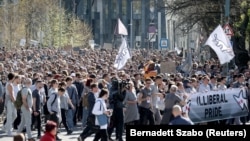 Skup "Budimo svi isti" na kojem su učesnici obučeni u sivo i nose transparente koji ironično osuđuju boje i raznolikost, Budimpešta 12. april 2025.