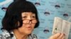 Гражданка Бакыт Ешжанова демонстрирует свой партбилет члена КПСС. Алматы, 16 августа 2011 года. 