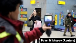 Kazakh personnel use a thermal scanner to detect travelers from China who may have symptoms possibly connected with the coronavirus at Almaty International Airport on January 21.