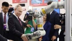 Russian President Vladimir Putin visits an exhibition at the Harbin Institute of Technology in Harbin as part of a 2024 state visit to China. 