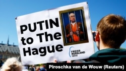 Protesters rally outside the International Court of Justice at The Hague to demand the arrest of Russian President Vladimir Putin on May 7, 2024.